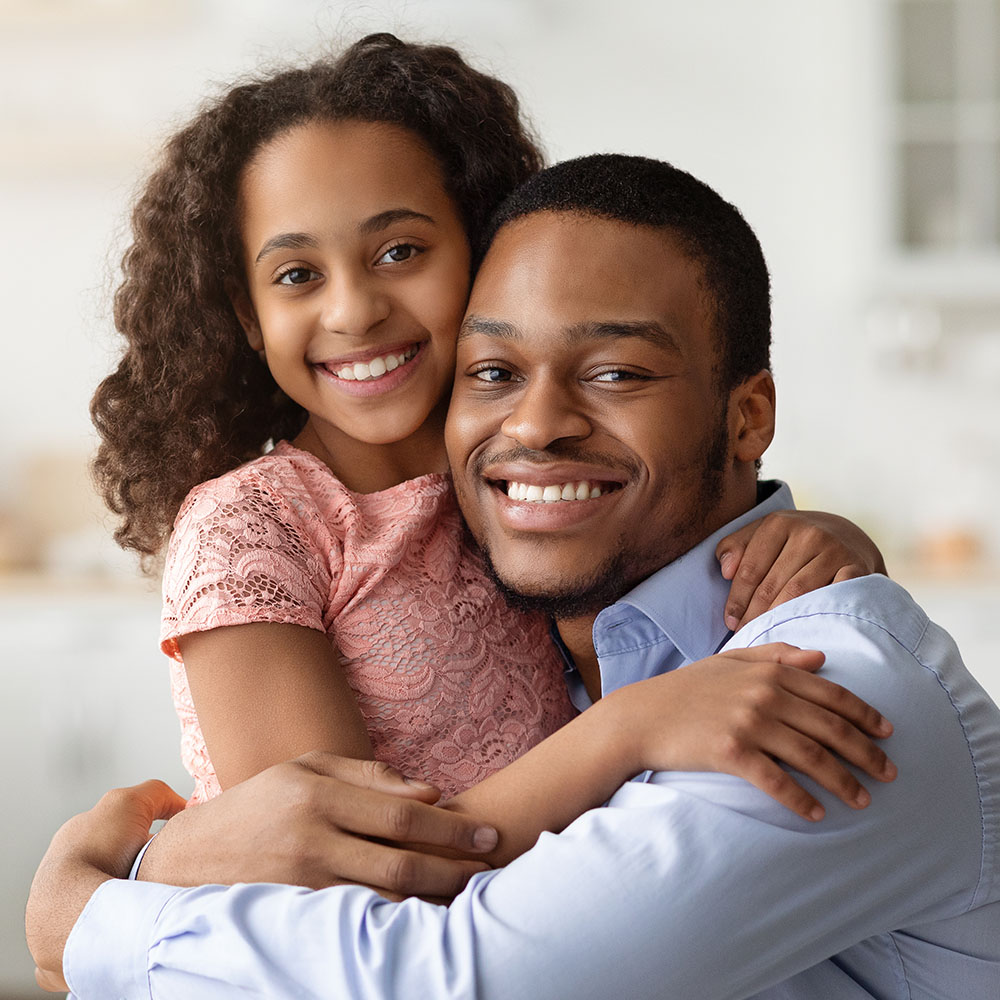 Dad hugging daughter